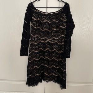 Black lace dress with boat neck and asymmetrical hem